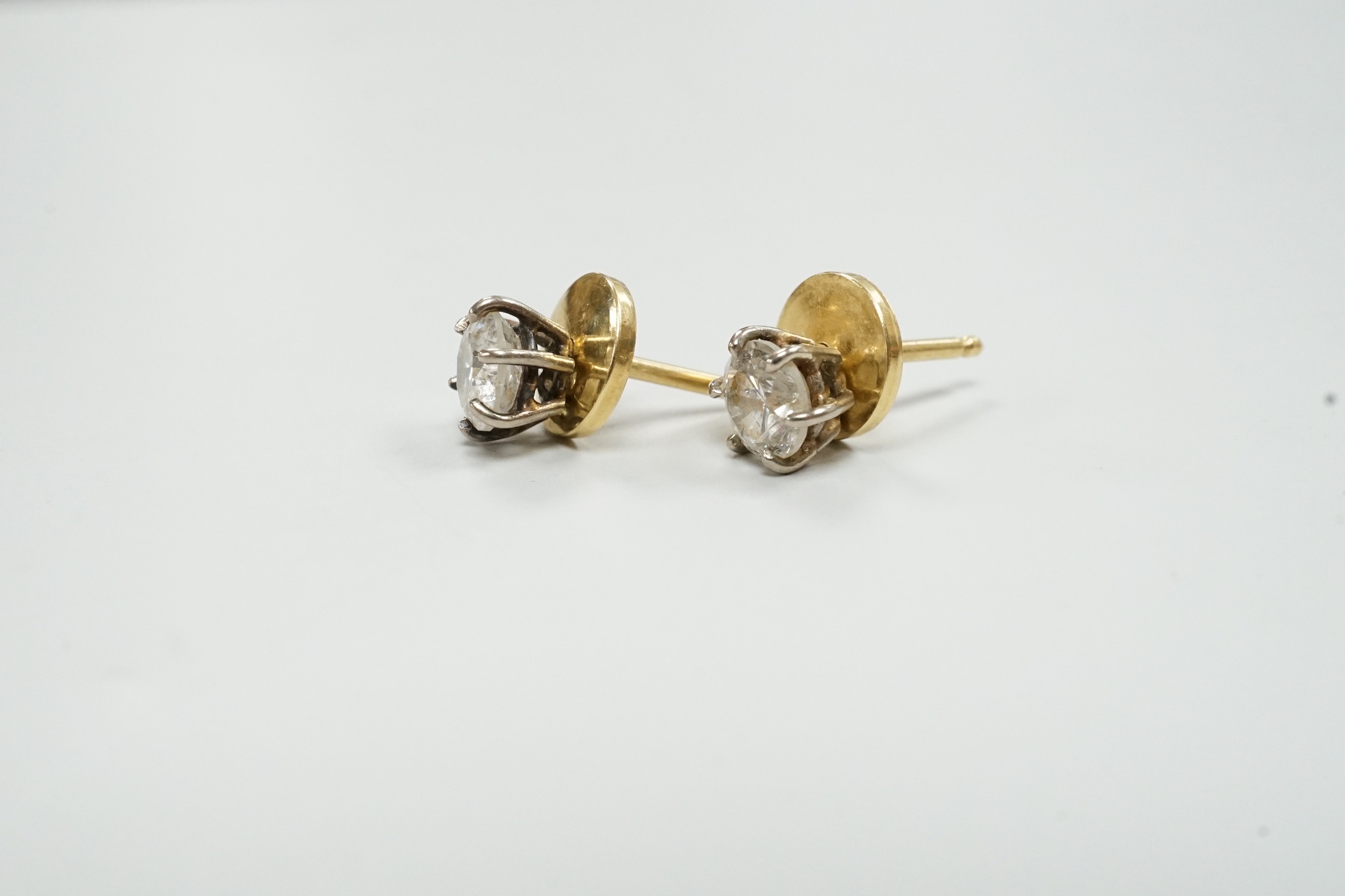A pair of yellow metal (18ct French poincon mark on discs) and solitaire diamond set ear studs